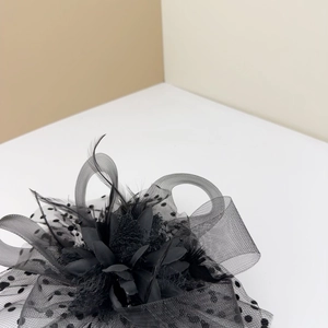 Close-up of vintage black mesh fascinator showing intricate feather and flower textures