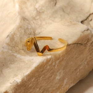 French style 18K gold plated stainless steel heartbeat open ring on a beige stone base