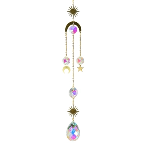 Detailed view of sun and moon metal charms with rainbow crystal prisms and golden chain
