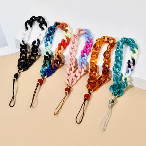 Detail of chunky resin phone chain straps in assorted vibrant colors and glossy finishes