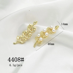 Detailed view of gold rose branch pendants with dimensions 46mm by 14mm and pearl accents
