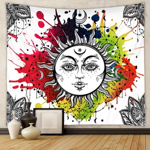 Bohemian sun and moon wall tapestry with colorful artistic splatter on a grey wall