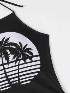 Close-up of tropical palm tree print on black halter bikini top with smooth stitching