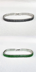 Detailed shot of black and emerald zircon tennis bracelets with vintage silver settings