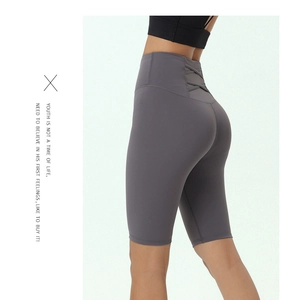 Close-up of high-waist yoga shorts featuring cross-strap detail on the back waistline