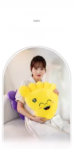 Close-up of soft yellow plush pillow featuring smiling face and spider embroidery details