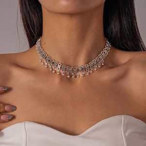 Close-up of Bohemian silver-tone choker with hollow floral patterns and bead tassels