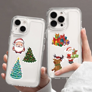 Detailed view of two transparent iPhone cases with festive Christmas stickers and Santa