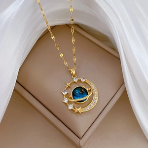 Golden planet and moon pendant necklace with navy blue stone and sparkling zircons