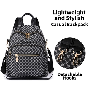 Detailed close-up of the detachable metal hook on this black clover print backpack