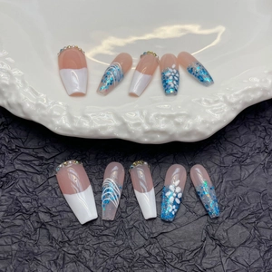 Extra long French press-on nails with blue glitter, hand-painted flowers and rhinestones