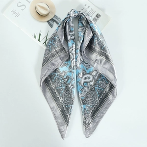 Vintage blue paisley printed silk-like square scarf styled on a white background