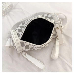 Detailed top view of a cylindrical checkerboard crossbody bag with a white zipper and strap