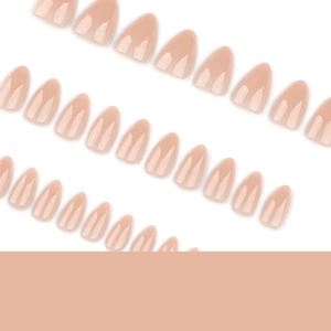 Short almond nude press-on nails in a glossy finish arranged diagonally on white background