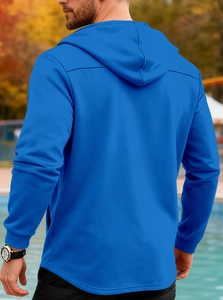 Rear view of cobalt blue hooded jacket with drawstring hood and ribbed cuffs on model
