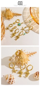 Detailed view of 14K gold sea star and dolphin jewelry set with turquoise beads