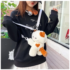 Detail of cute plush cat bag with orange heart embroidery and adjustable white strap