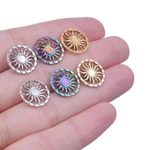 Close-up of hollow sun-shaped 304 stainless steel pendants in silver, gold, and rainbow finish