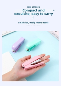 Close-up of three macaron-colored mini staplers in pink, purple, and cyan blue for office