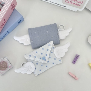 Detail of star pattern envelope pouches with plush wings and heart snap buttons