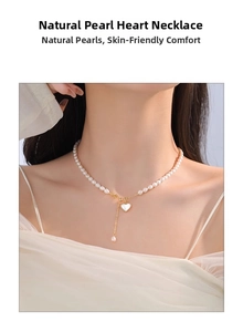 Detail of natural freshwater pearl necklace with gold heart shell pendant and tassel charm
