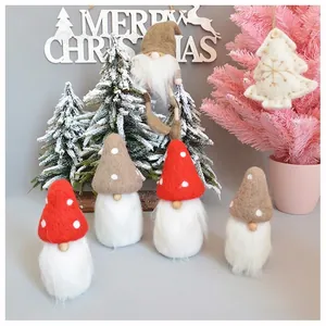 Handmade wool felt Christmas gnomes with white beards and festive hats for holiday tree decor