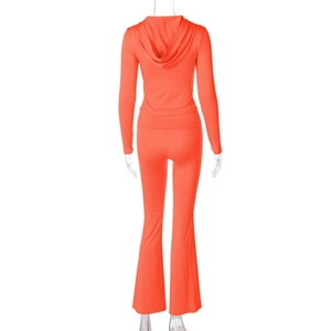 Rear view detail of bright orange hooded tracksuit with flared pants on a mannequin