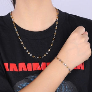 Close-up of 4.5mm stainless steel coffee bean link bracelet on model wearing black tee