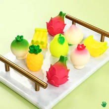 Collection of colorful mini fruit squishy toys on a decorative marble tray with gold handles