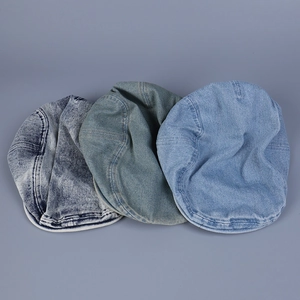 Flat lay of three vintage washed denim ivy caps in dark, medium, and light blue shades