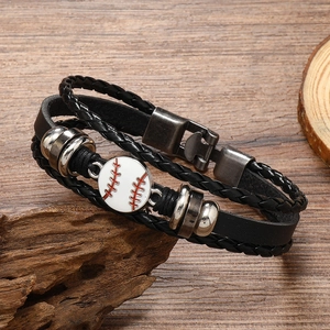 Detail of multi-layer black leather bracelet featuring a baseball charm and metal clasp