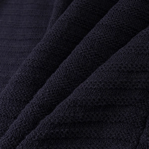 Close-up of premium dark navy knit fabric showing detailed texture and soft woven fibers