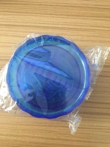 Blue plastic garlic twist press and mincer tool shown in its transparent packaging