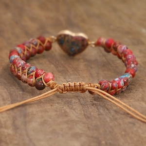 Macro detail of adjustable knotted closure on handmade woven emperor stone heart bracelet