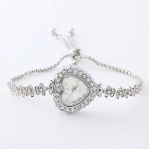 Detail of silver heart-shaped watch with crystal accents and adjustable bracelet
