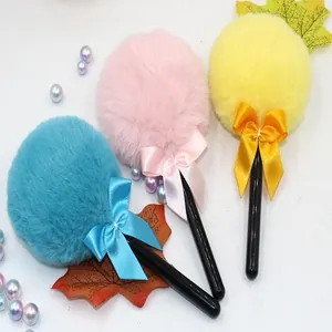 Close-up of colorful lollipop makeup puffs with soft plush texture and ribbon bow detail