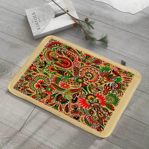 Detail view of ethnic paisley flannel floor mat with vibrant colors on wooden floor
