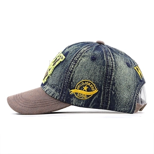 Detail view of washed denim baseball cap with yellow star embroidery and adjustable back