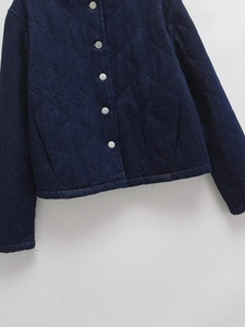 Dark blue denim quilted jacket with silver metal snap buttons and stand collar