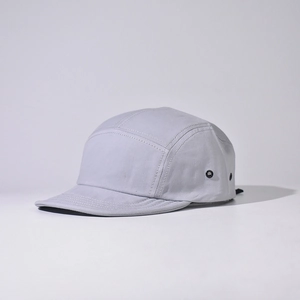 Detail of light grey 5-panel camper hat with metal eyelets and premium cotton texture