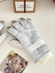 Detail of cute rabbit print ski gloves with adjustable wrist strap and knit windproof cuffs