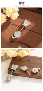 Macro detail of cat devil ear cartilage stud featuring micro-set cubic zirconia and screw thread