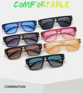 Flat lay of modern one-piece men's sunglasses in seven vibrant colors for stylish fashion