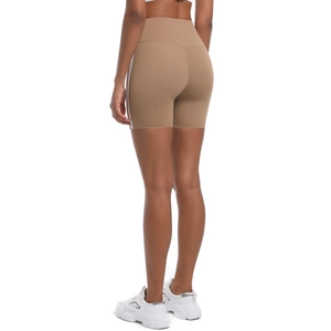 Detail view of khaki high-waisted yoga shorts with side stripes and body-hugging fit