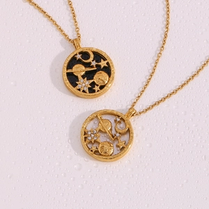 Macro shot of gold celestial necklaces with moon and star pendants on a droplet background