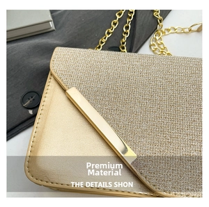 Close-up of champagne gold glitter fabric and smooth leather texture on chain bag