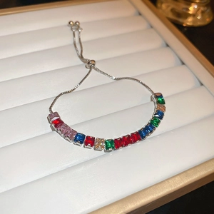 Macro detail of silver bracelet featuring colorful rectangular crystals and adjustable drawstring