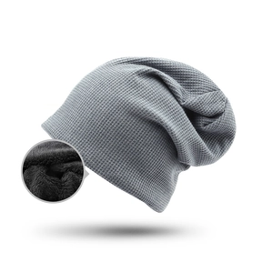 Detail view of grey waffle knit beanie with thick black fleece lining for winter warmth