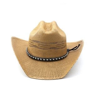 Detail of woven straw cowboy hat featuring breathable crown vents and decorative tassels