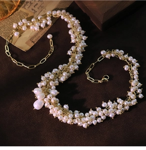 Artistic detail of vintage freshwater pearl necklace and bracelet with gold accents